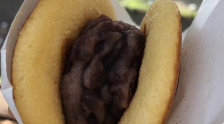 Eating mini dorayaki in the business district